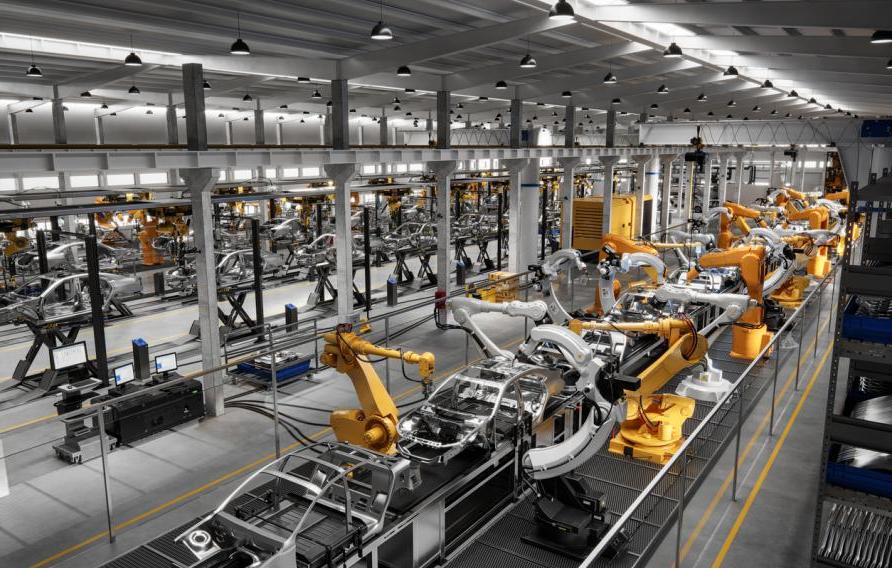 High angle view of cars on production line in factory. Many robottic arms doing welding on car metal body in manufacturing plant. Image in 3D render.